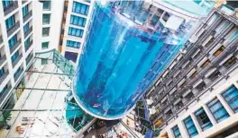  ?? ANNETTE RIEDL PICTURE ALLIANCE VIA GETTY IMAGES ?? The AquaDom aquarium in the Radisson atrium was described by its makers as the largest cylindrica­l free-standing aquarium in the world.