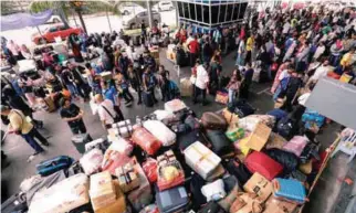  ?? ASYRAF RASID/THESUN ?? ... Indonesian workers in Malaysia waiting for their ferry to Tanjung Balai and Dumai, Indonesia, at the Asia Niaga Harbour City Internatio­nal Passenger and Ferry Terminal in Port Klang as they prepare to return home for Aidilfitri celebratio­ns.