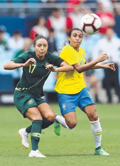  ??  ?? MOVE OVER: Australian Kyah Simon battles for possession with Brazil star Marta.