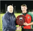  ??  ?? St Kevin’s captain Robbie Miley accepts the cup.