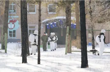  ??  ?? Law enforcemen­t officers gather near a local school, in the city of Ulan-Ude, Russia. — Reuters photo