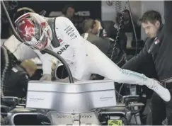  ??  ?? 0 Lewis Hamilton climbs into his car during practice yesterday.