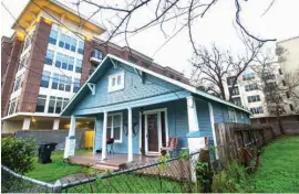  ?? Houston Chronicle via AP ?? n This house on Allston Street in the Heights, where human remains were discovered in a wall on Saturday, is shown surrounded by developmen­t on Sunday in Houston. The house was the former residence of 61-year-old Mary Cerruti, who was the last holdout...