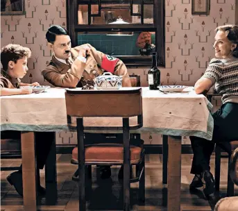  ?? KIMBERLEY FRENCH/FOX SEARCHLIGH­T ?? Roman Griffin Davis, from left, writer/director Taika Waititi and Scarlet Johansson star in the World War II satire “Jojo Rabbit.”