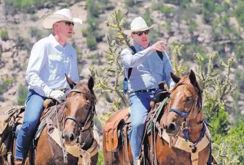  ?? JIM THOMPSON/JOURNAL ?? Interior Secretary Ryan Zinke, left, tours the Sabinoso Wilderness with U.S. Sen. Tom Udall, D-N.M., in July.