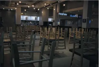  ?? THE ASSOCIATED PRESS FILE PHOTO ?? The Pennsylvan­ia Restaurant & Lodging Associatio­n will accept applicatio­ns starting on Thursday, April 23for emergency grants for hospitalit­y workers impacted by the coronaviru­s pandemic. In this March 16, 2020file photo, chairs hang stacked on empty tables at a closed restaurant in New York.