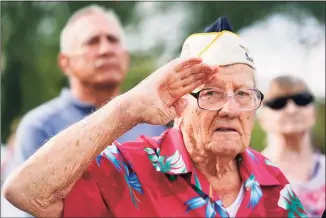  ?? Ross D. Franklin / Associated Press ?? Pearl Harbor survivor Edward Miclavcic salutes during the national anthem at a Pearl Harbor Remembranc­e Day Ceremony at the USS Arizona Anchor Memorial on Tuesday in Phoenix.