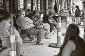  ?? Nati Harnik / Associated Press ?? Job seekers exercise social distancing as they wait to be called into the Heartland Workforce Solutions office in Omaha, Neb. Nebraska reinstated job search requiremen­ts this week for most people claiming jobless benefits.