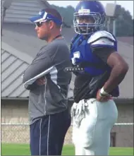  ?? ALEX FARRER \ staff ?? Gordon Central coach Chad Fisher (left), DJ Prather and the Warriors host Coosa on Friday in their regular season opener at Ratner Stadium.