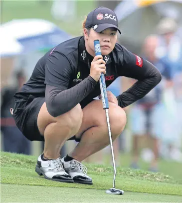  ?? PHOTOS BY PATTANAPON­G HIRUNARD ?? Ariya Jutanugarn lines up a putt during the first round.