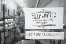  ?? REUTERS ?? A Help wanted sign is seen in the window of a bakery in Ottawa in 2017.