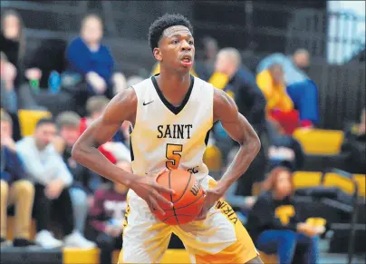  ?? GARY MIDDENDORF/DAILY SOUTHTOWN PHOTOS ?? St. Laurence’s Jeremiah Williams looks to pass against St. Francis de Sales on Friday. Williams had 27 points and seven rebounds.