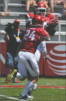  ?? NWA Democrat-Gazette/Andy Shupe ?? CHANGING PLACES: Playing tight end, Jamario Bell makes a touchdown catch behind defensive back Ryder Lucas (24) during Arkansas’ 2016 Red-White game in Fayettevil­le. Bell, of Junction City, has moved to Hog linebacker in the Razorbacks’ new 3-4...