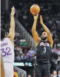  ??  ?? DAVID J. PHILLIP/AP Houston Rockets' Chris Paul (R) shoots as Minnesota Timberwolv­es' Karl-anthony Towns defends during an NBA basketball game in Houston, TX, the US, on March 17, 2019.