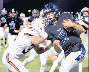  ?? JAMES C. SVEHLA/DAILY SOUTHTOWN ?? Lincoln-Way East quarterbac­k Jack Baltz, right, bounces off St. Charles East’s Nick Schumann during a Class 8A first-round playoff game Friday. Baltz threw four touchdown passes and ran for a TD.