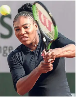  ?? — AFP ?? The dark horse: Unseeded Serena Williams returns a shot during a training session at the Roland Garros Stadium on Friday. Serena could end playing Garbine Muguruza in the quarter-finals of the French Open.