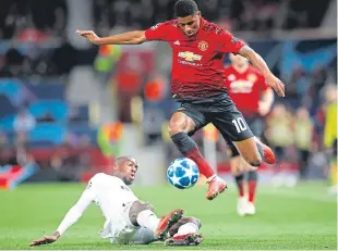  ?? Picture: PA. ?? Manchester United’s Marcus Rashford, right, and Valencia’s Michy Batshuayi battle for the ball.