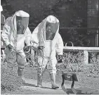  ??  ?? British responders in biohazard suits in Salisbury. AFP/GETTY IMAGES