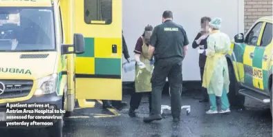  ??  ?? A patient arrives at Antrim Area Hospital to be assessed for coronaviru­s yesterday afternoon