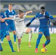  ??  ?? Brighton’s Yves Bissouma evades Luke Ayling