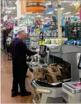  ?? LISA POWELL / STAFF ?? LEFT: A customer pays for his purchase at the self-checkout lanes in the new Cornerston­e of Centervill­e Kroger.
KARA DRISCOLL / STAFF CENTER: National grocers like Meijer were listed among the companies posting the most area job ads, according to...