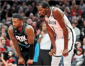  ?? — AFP ?? Take five: damian Lillard (left) of the Portland trail blazers and Kevin durant of the brooklyn Nets taking a break during the third quarter of
their Nba game.