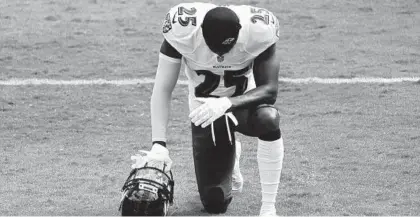  ?? JULIO CORTEZ/AP ?? Ravens cornerback Tavon Young kneels at the end zone before a game against the Browns on Sept. 13 in Baltimore.