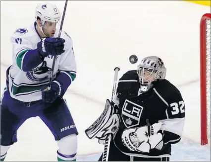  ??  ?? Los Angeles goalie Jonathan Quick makes a save with Ryan Kesler in attendance during the third period of the Canucks’ win Wednsday night at Los Angeles.