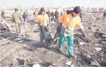  ?? — AFP photo ?? Rescue teams work at the scene a er a Ukrainian plane carrying 176 passengers crashed near Imam Khomeini airport in the Iranian capital Tehran early in the morning, killing everyone on board.