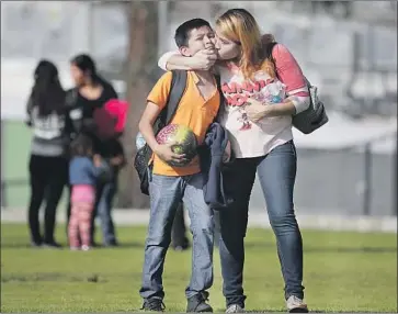  ?? Robert Gauthier Los Angeles Times ?? DIEGO ROBLEDO, 11, is reunited with his mother, Wendy Juarez, after gunfire led to a lockdown at Sal Castro Middle School. L.A. Unified’s efforts to prevent such violence include campus policing and counseling.