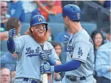  ?? WENDELL CRUZ, USA TODAY SPORTS ?? Dodgers players Justin Turner, left, and Cody Bellinger have slugging percentage­s above .500.