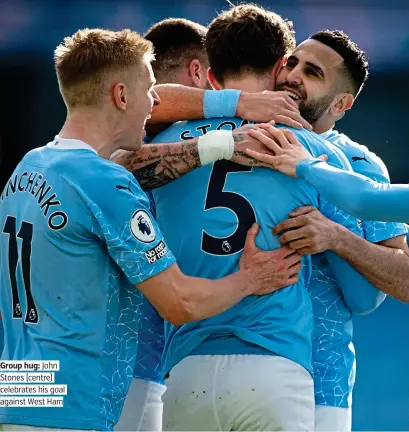  ??  ?? Group hug: John Stones (centre) celebrates his goal against West Ham