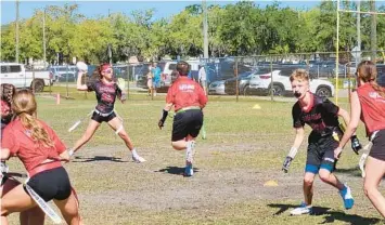  ?? TAMPA BAY TIMES PHOTOS ?? Quarterbac­k Sophie Spiegel, a Land O’Lakes High freshman, leads her coed flag football team’s offense during recreation­al league competitio­n at the Land O’Lakes Recreation Complex on Sunday. The girls and their parents are calling on the Pasco County School Board to add competitiv­e flag football to school athletics.