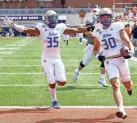  ?? ALONZO ADAMS/AP ?? Tulsa linebacker Justin Wright (30) runs an intercepti­on in for a touchdown against Oklahoma State as Tulsa linebacker Yohance Burnett (35) celebrates last Saturday.