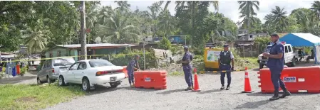  ?? Photo: Kelera Sovasiga ?? Members of the Fiji Police Force guard the entrance to the quarantine­d Nabua red zone along Ratu Mara Road on April 16, 2020.