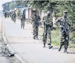  ?? AFP ?? Burundian soldiers withdraw from the restive Cibitoke neighbourh­ood in Bujumbura after a police operation on Monday.