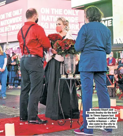  ??  ?? Amanda Stuart and Ronnie Dooley tie the knot in Times Square last month — instead of in her native Arkansas — after she came to the city to treat COVID-19 patients.