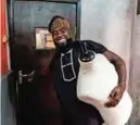  ??  ?? This file photo shows Nigerian traditiona­l fashion designer Omobolaji Ademosu holding a mannequin as he leaves his office in Lagos.