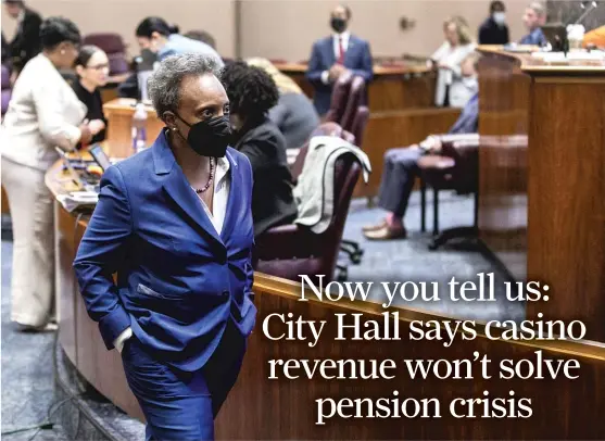  ?? PAT NABONG/SUN-TIMES ?? Mayor Lori Lightfoot walks around City Council chambers Wednesday in advance of the casino vote.