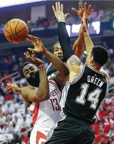  ?? Karen Warren / Houston Chronicle ?? Rockets guard James Harden, left, runs into a human road block in the form of the Spurs’ Kawhi Leonard, center, and Danny Green in Game 3 on Friday night at Toyota Center.