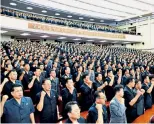  ??  ?? A meeting of North Korea’s central committee as thousands marched in Pyongyang to vow ‘sacred war’ with US.