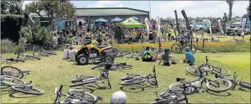  ??  ?? ALL FLAGGED OUT: Cyclists enjoy a well deserved rest at the end of last year’s K2K event