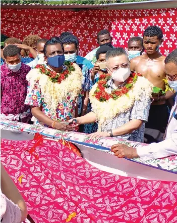  ?? Photo: Salote Qalubau ?? The Minister for Youth and Sports Parveen Bala Kumar and the Chinese Ambassador to Fiji Qian Bo hand over of the fiber glass boat to the Natawarau settlement in Ba on December 23,2021.