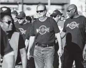  ?? Kirthmon F. Dozier / TNS ?? UAW president Gary Jones, center, retired abruptly Wednesday amid union discontent after General Motors filed suit against Fiat Chrysler, alleging racketeeri­ng. Fiat denied accusation­s of union bribery.
