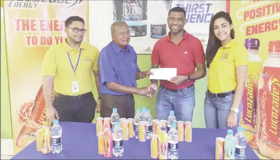  ??  ?? Ansa McAl’s Non-Alcoholic brand Manager Errol Nelson hands over the sponsorshi­p to race organizer, Hassan Mohammed in the presence of Lucozade brand manager Faris Mohamed and ICool Water Marketing Assistant Gabrielle Lopes.