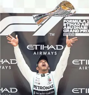  ?? ALI HAIDER/EPA-EFE ?? British Formula One driver Lewis Hamilton of Mercedes AMG GP celebrates on the podium Sunday after winning the Abu Dhabi Grand Prix.