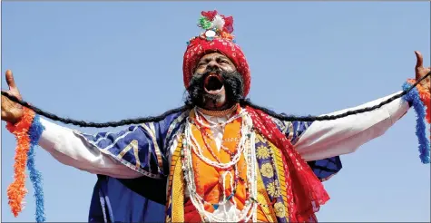  ??  ?? A man laughs as he shows his moustache during a competitio­n at the Pushkar Fair in Rajasthan on Saturday. REUTERS