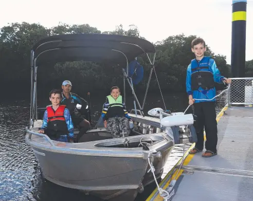  ?? Picture: STEWART McLEAN ?? GOOD NEWS: Edmonton dad Nat Dunston and his boys Archie, 10, Charlie, 9, and Harry, 8, use the new floating jetty at the Edmonton boat ramp.