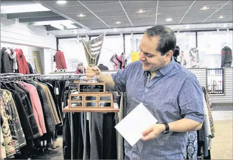  ?? WENDALYNN JONES ?? Phinneys clothing store owner Andrew Zebian is the inaugural winner of The David White Visions of Kentville Award after his business won “The Jolly Holly Decorating Contest.”