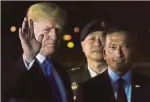  ?? REUTERS PIX ?? United States President Donald Trump (left) waving next to Singapore Foreign Minister Vivian Balakrishn­an after arriving in Singapore yesterday.